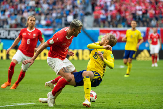 Valon Behrami of Switzerland tackles Emil Forsberg of Sweden