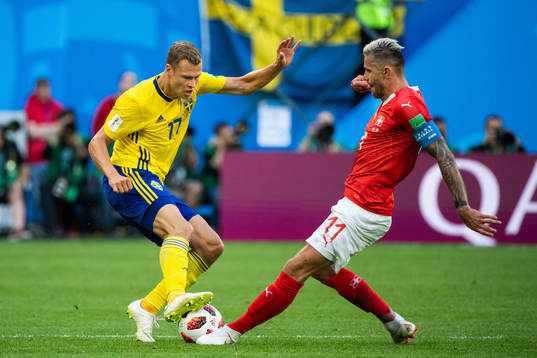 Viktor Claesson of Sweden adn Valon Behrami of Switzerland