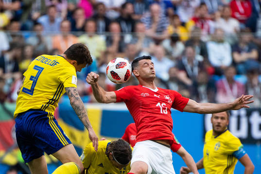 Victor Nilsson Lindelöf of Sweden and Blerim Dzemaili of