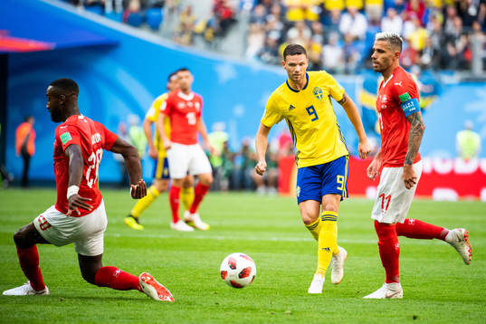 Marcus Berg of Sweden and Valon Behrami of Switzerland