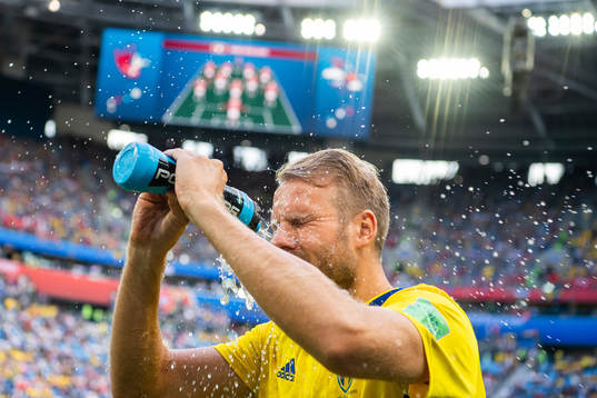 Ola Toivonen sprays water in his face prior to the FIFA