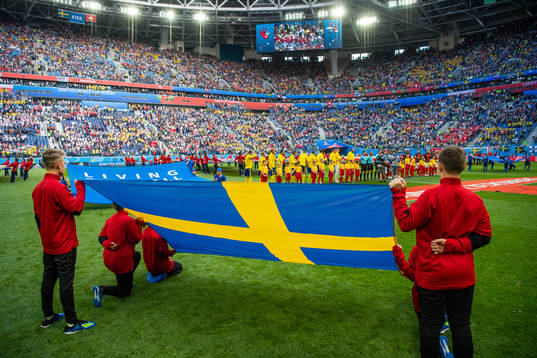 Line up with a Swedish flag in the foreground prior to the