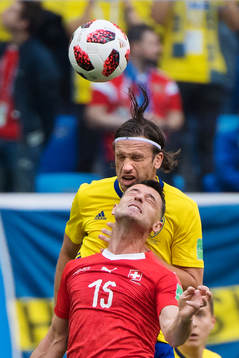 Gustav Svensson of Sweden and Blerim Dzemaili of Switzerland