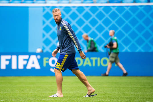 Pontus Jansson of Sweden inspects the pitch prior to the