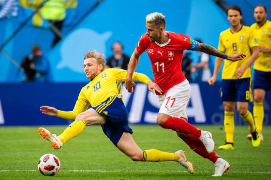 Emil Forsberg of Sweden competes for the ball with Valon