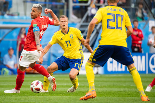 Viktor Claesson of Sweden and Valon Behrami of Switzerland