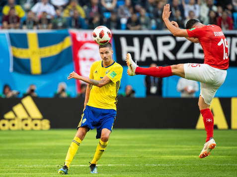 Mikael Lustig of Sweden and Blerim Dzemaili of Switzerland