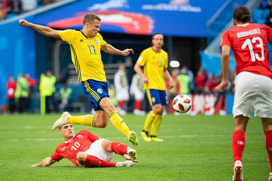 Granit Xhaka of Switzerland competes for the ball with