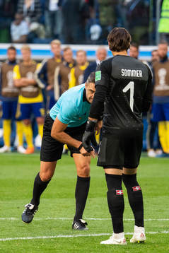 The referee calls a free kick in a situation