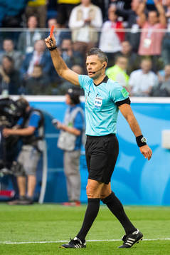 The referee awards Michael Lang of Switzerland with a red