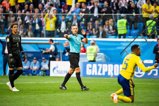 The referee calls for a penalty (later it became a free kick