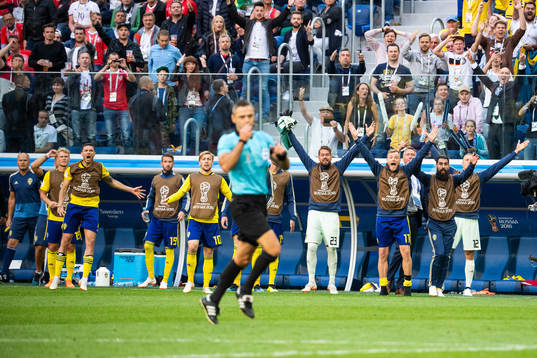 Players of Sweden reacts as the referee awards a penalty