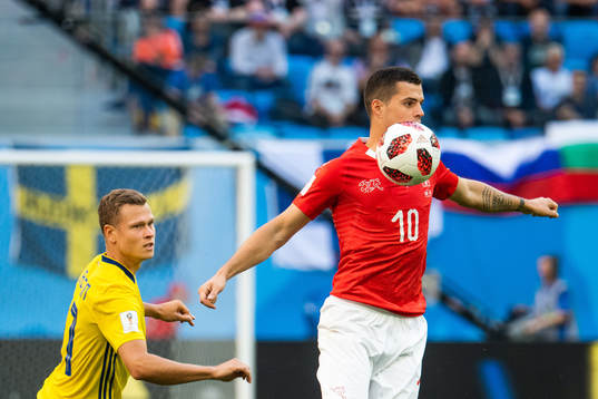 Viktor Claesson of Sweden and Granit Xhaka of Switzerland