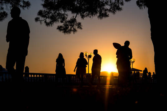 People walks in the sunset