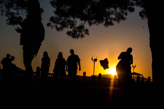 People walks in the sunset