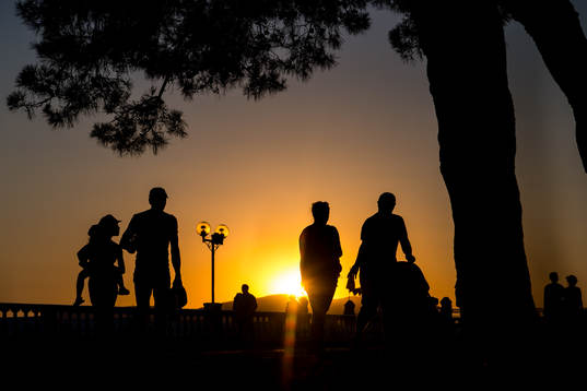 People walks in the sunset