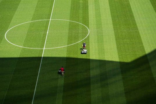 Workers prepare the pitch at Samara Arena