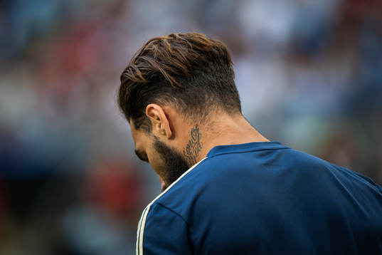 A tattoo with the text "son of god" seen