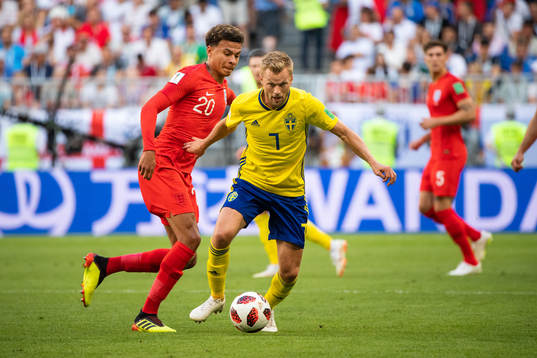 Dele Alli of England and Sebastian Larsson of Sweden