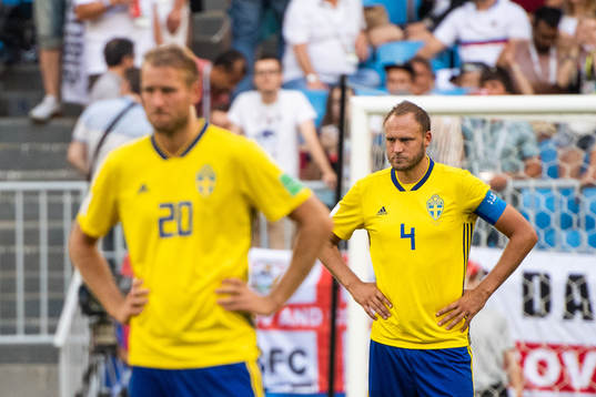 Ola Toivonen and Andreas Granqvist of Sweden looks dejected