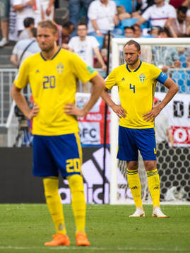 Ola Toivonen and Andreas Granqvist of Sweden looks dejected