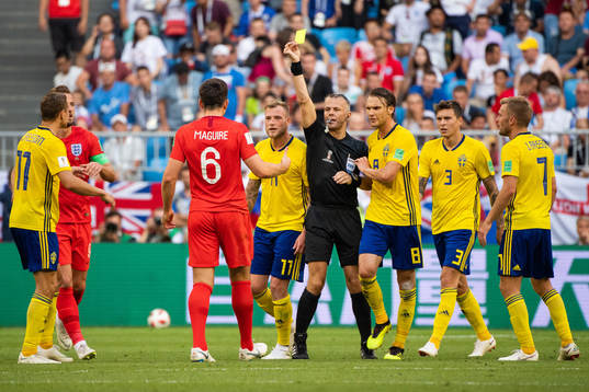 Harry Maguire of England gets a yellow card