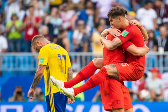 John Guidetti of Sweden looks dejected while John Stones of
