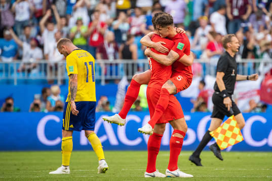 John Guidetti of Sweden looks dejected while John Stones of