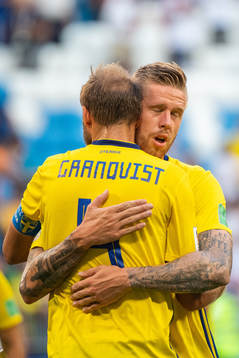 Pontus Jansson hugs Andreas Granqvist of Sweden looking