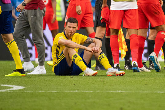 Marcus Berg of Sweden sits down looking dejected
