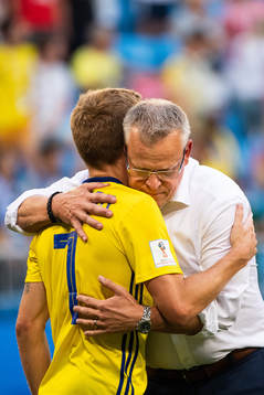 Sebastian Larsson hugs head coach Janne Andersson of Sweden