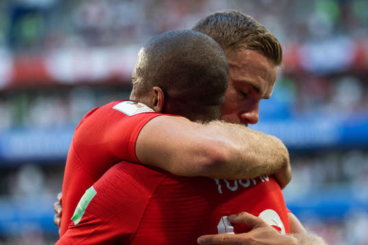 Ashley Young and Jordan Henderson of England  hugs when
