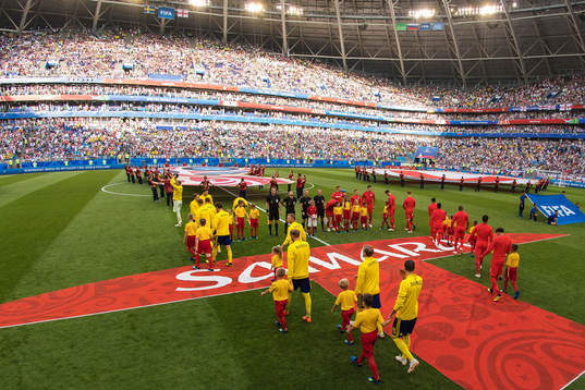 Players of team Sweden and England make their entrance to