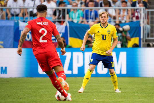 Kyle Walker of England and Emil Forsberg of Sweden