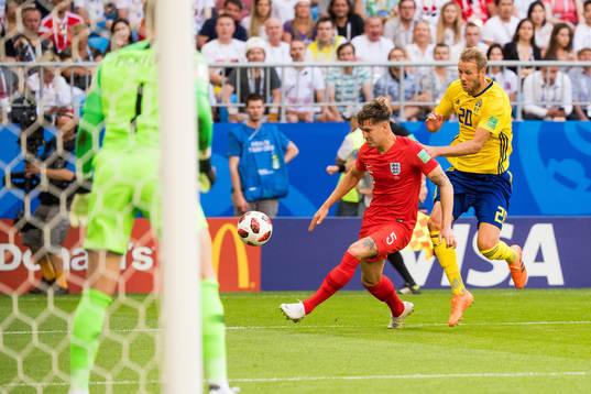 John Stones of England and Ola Toivonen of Sweden
