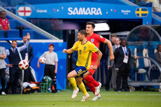 Marcus Berg of Sweden and Harry Maguire of England