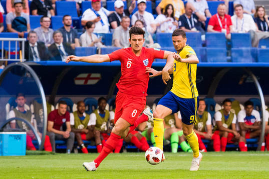 Harry Maguire of England and Marcus Berg of Sweden