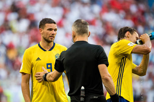 Marcus Berg of Sweden argues with the referee