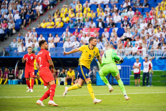 Marcus Berg of Sweden and goalkeeper Jordan Pickford of