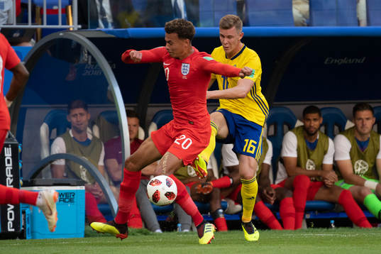 Dele Alli of England and Emil Krafth of Sweden