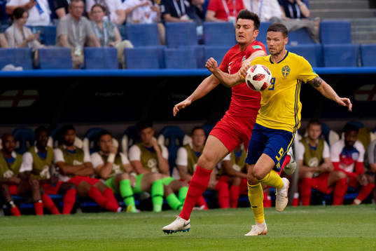 Harry Maguire of England and Marcus Berg of Sweden