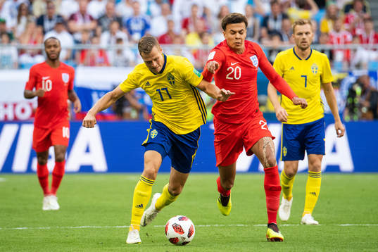 Viktor Claesson of Sweden competes for the ball with Dele