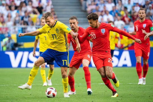 Viktor Claesson of Sweden competes for the ball with Dele