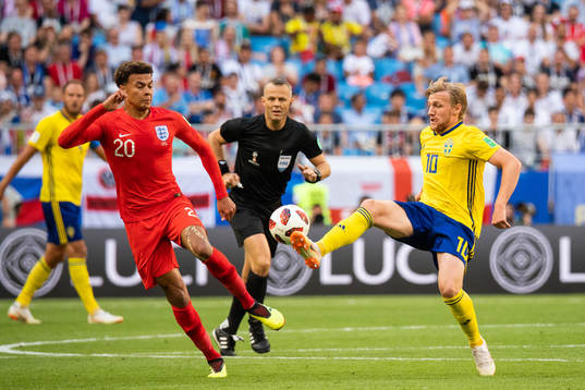 Dele Alli of England and Emil Forsberg of Sweden