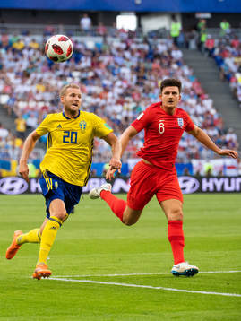 Ola Toivonen of Sweden competes for the ball with Harry