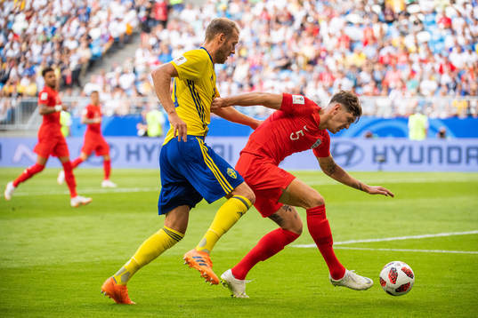 Ola Toivonen of Sweden competes for the ball with John