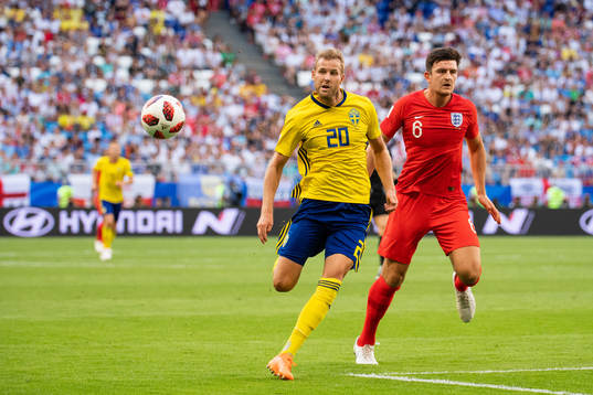 Ola Toivonen of Sweden competes for the ball with Harry