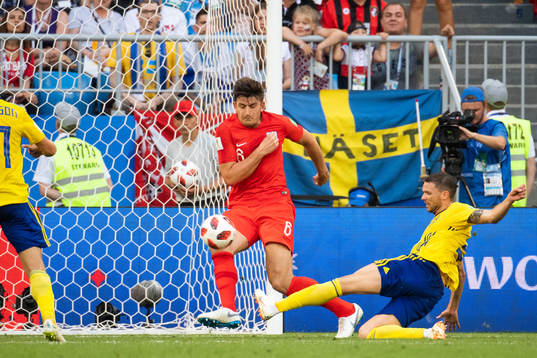 Harry Maguire of England defends against Marcus Berg of