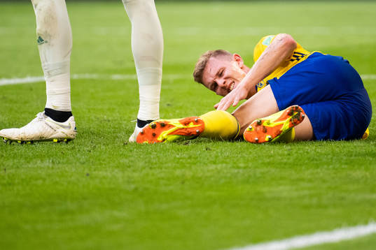 Viktor Claesson of Sweden reaches for his leg