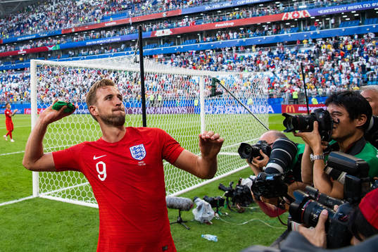 Harry Kane of England throws his captain arm band when he